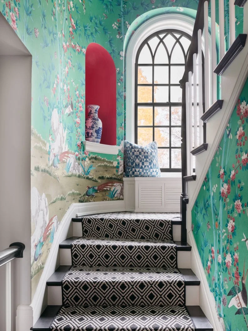 Wallpapered Stairway With an Arched Mirror and Niche