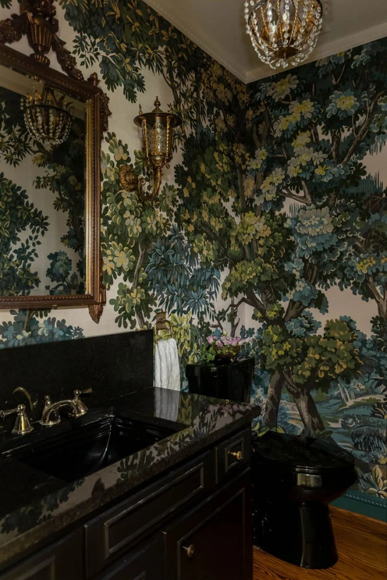 Once again leaning into green, draping the guest powder room in a bold floral wallpaper in green continued a theme of green and of florals in this Kentucky home.