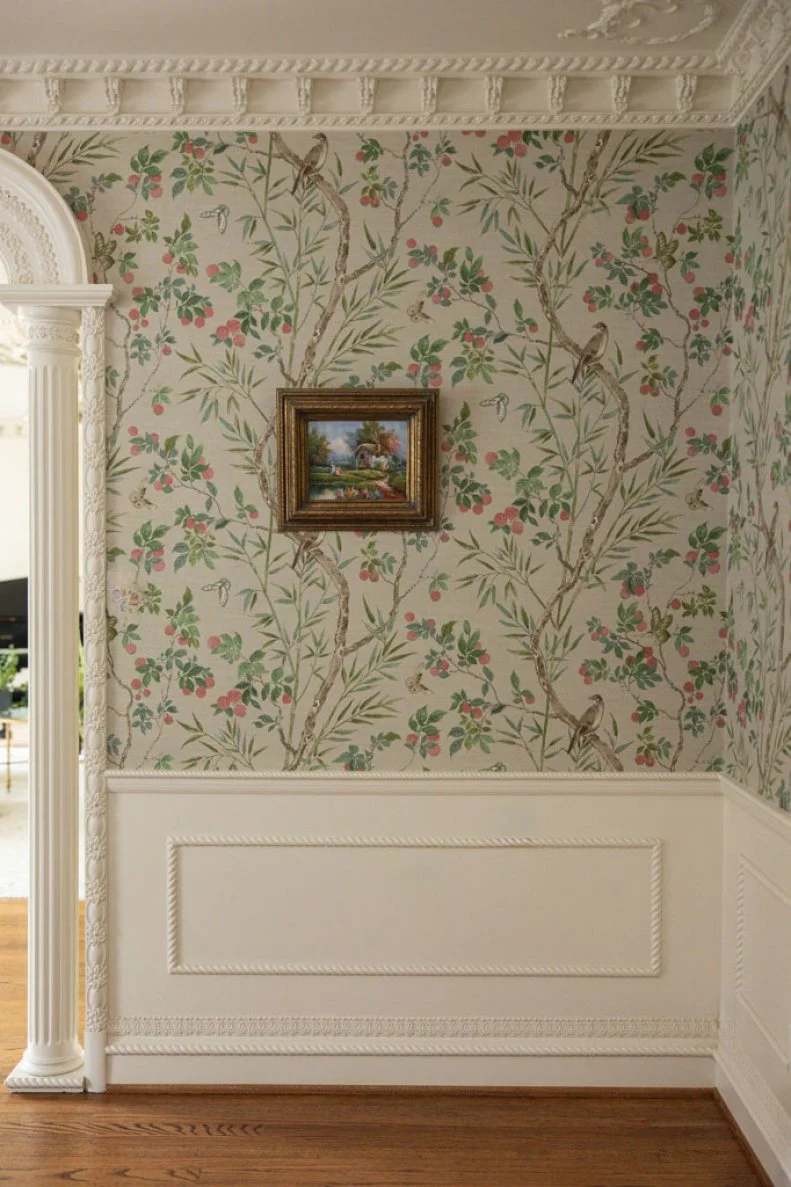 More elaborate molding that beautifully complements the floral wallpaper in this formal dining room.