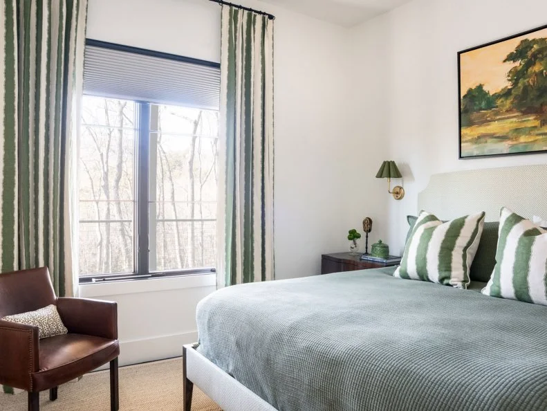 Green and White Bedroom With Leather Chair