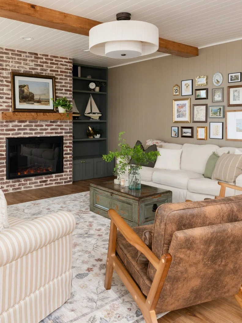 After of Team Mika Ty Pennington’s living room renovation that included adding a new fireplace and wood beams, as seen on Battle on the Beach, Season 5.