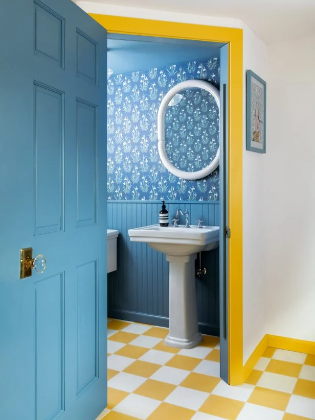 Blue-and-Yellow Bathroom With Wallpaper and Checkerboard Floors