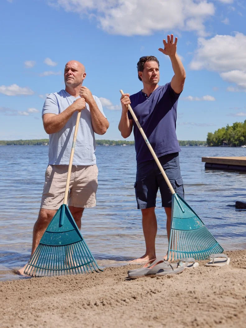 Hosts Bryan Baeumler and Scott McGillivary on beach, as seen on Renovation Resort, Season 3.