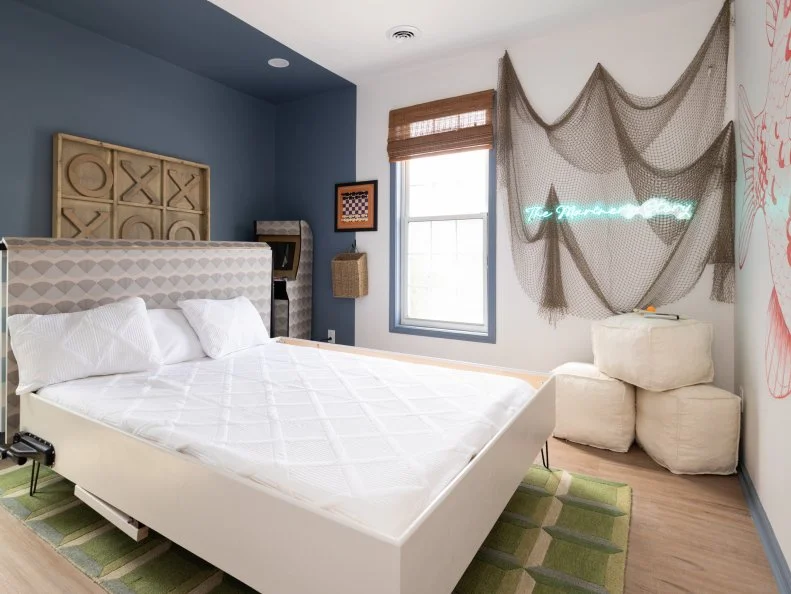 After of Team Mika Kleinschmidt’s guest bedroom and game room with a ping pong table that turns into a bed, as seen on Battle on the Beach, Season 5.