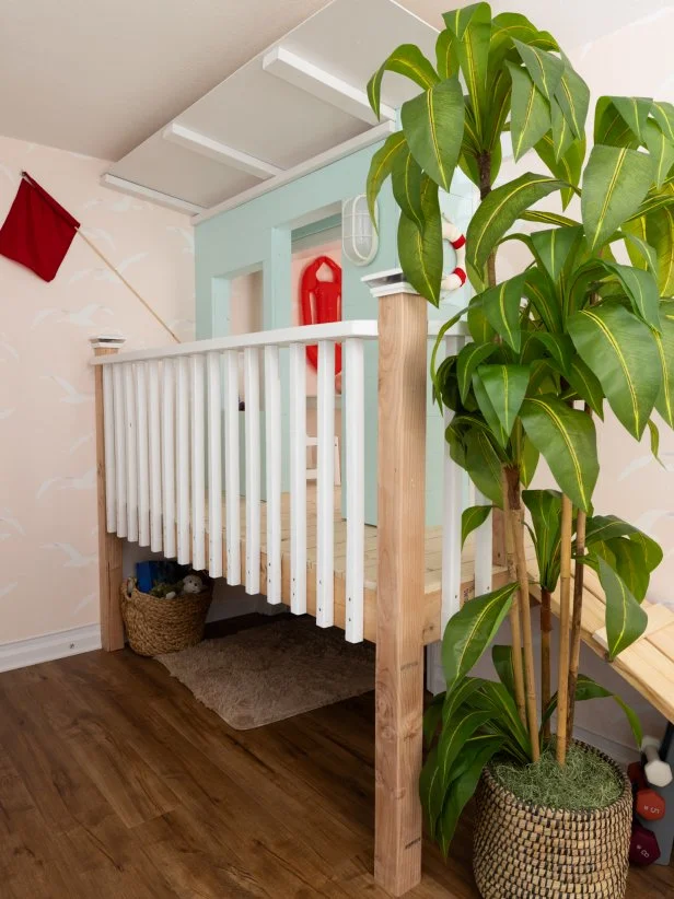 After of Team Ty Pennington’s guest bedroom that includes trundle beds and a lifeguard stand, as seen on Battle on the Beach, Season 5.