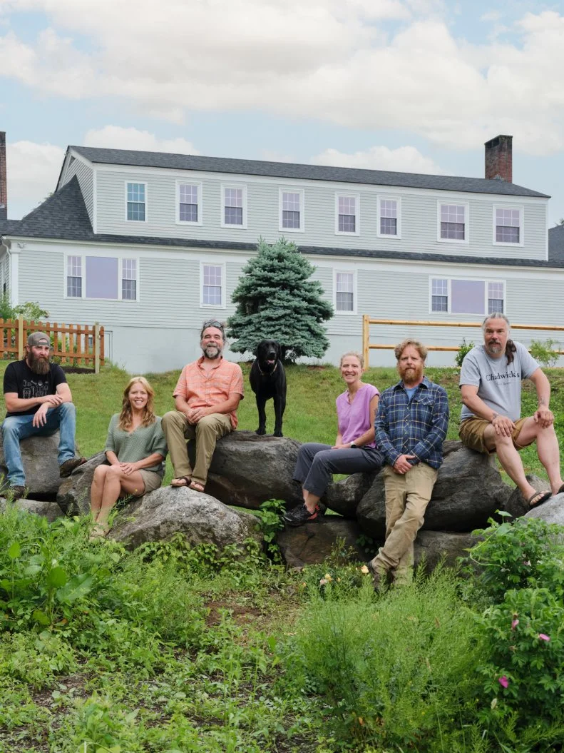 Main cast (L to R), Dixie, Ashley Morrill-Eldridge, Ryan Eldridge, Sarah and Chase Morrill, Jedi, and the dog, outside of the almost finished Inn, as seen on Maine Cabin Masters: All Inn.