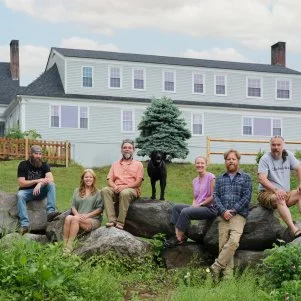 Main cast (L to R), Dixie, Ashley Morrill-Eldridge, Ryan Eldridge, Sarah and Chase Morrill, Jedi, and the dog, outside of the almost finished Inn, as seen on Maine Cabin Masters: All Inn.