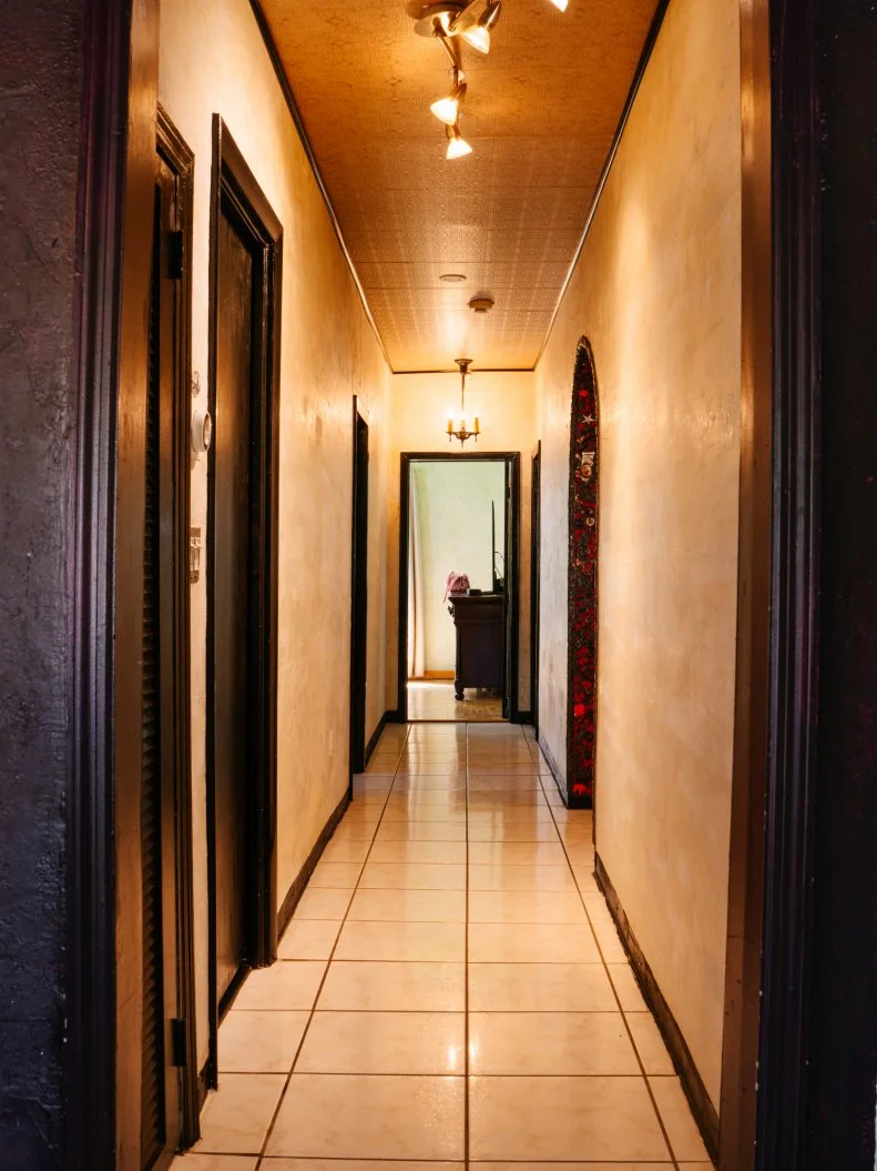 The main hallway in the Gaudy Greek Goddess home, as seen on Ugliest House in America, Season 8.