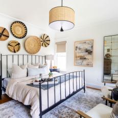 Eclectic Neutral Bedroom With Baskets on Wall