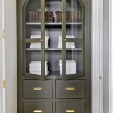Khaki Green Cabinet With White Towels