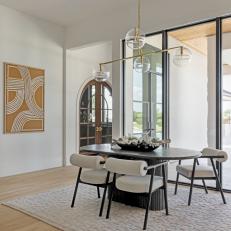 Modern Neutral Dining Room With Brown Art