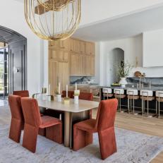 Kitchen and Contemporary Dining Area With Red Chairs