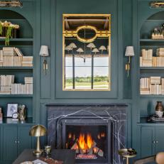 Blue Built In Bookshelves and Fireplace