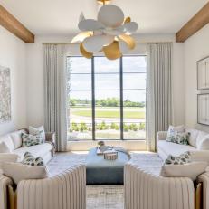 White Contemporary Sitting Room With Blue Ottoman