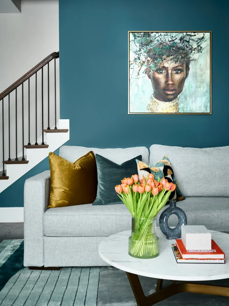 Teal Blue Living Room With Bold Art and a Gray Sofa