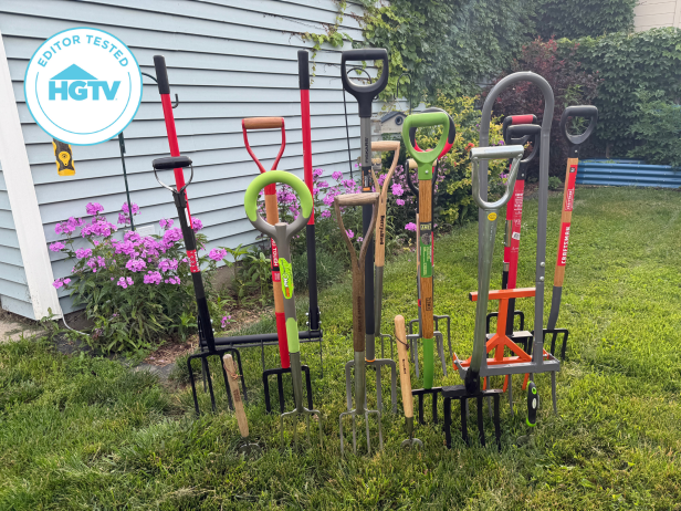 Garden forks stabbed in the grass and arranged together in a yard