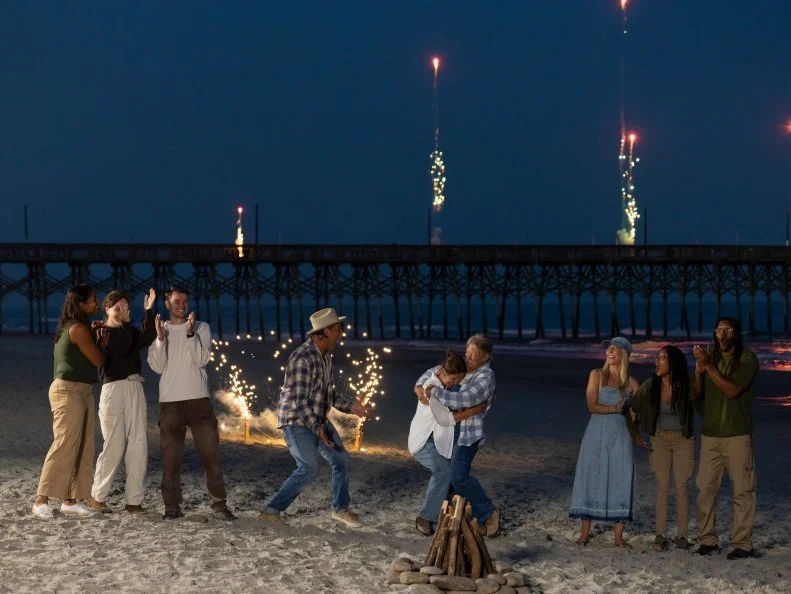 Teams and mentors react and celebrate as Ty Pennington’s team of Sydney Lorence and Michelle Mueller are announced as the overall winner, as seen on Battle on the Beach, Season 5.