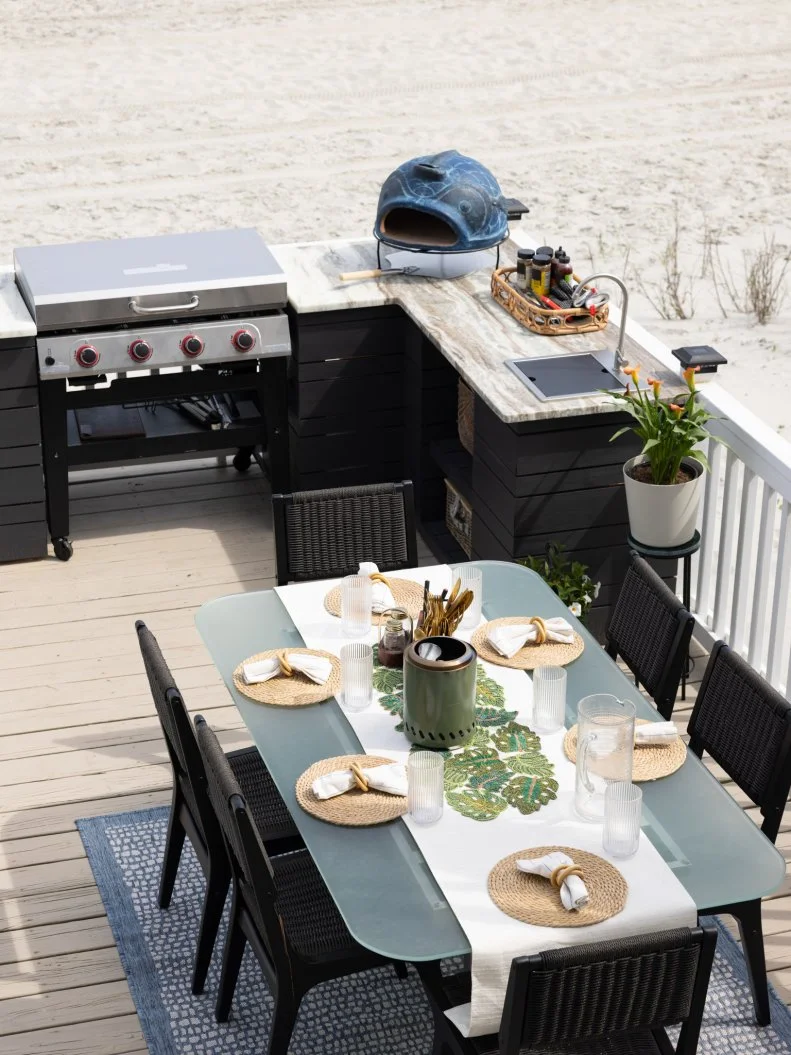 After of Team Mika Kleinschmidt’s beach front deck renovation including an outdoor kitchen, shower and dining area, as seen on Battle on the Beach, Season 5.