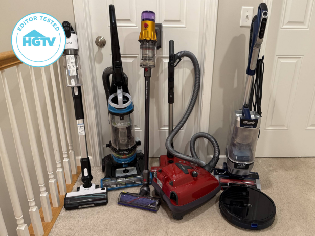 Six vacuums lined up against white doors in a home with beige carpet and an HGTV Editor Tested badge in left corner