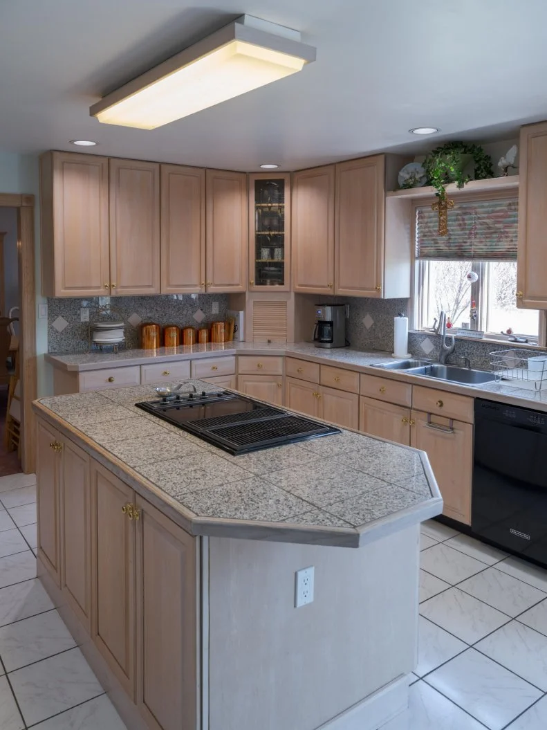 kitchen island with stove, counter tops, and sink, as seen on Totally 90s House, Season 1.