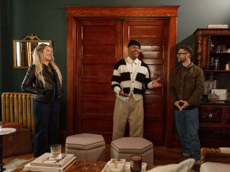 Host Anna Camp, and Judges Michel Smith-Boyd and Jack Osborne react to the Bihl Manor living room, as seen on A Very Haunted Renovation, Season 1