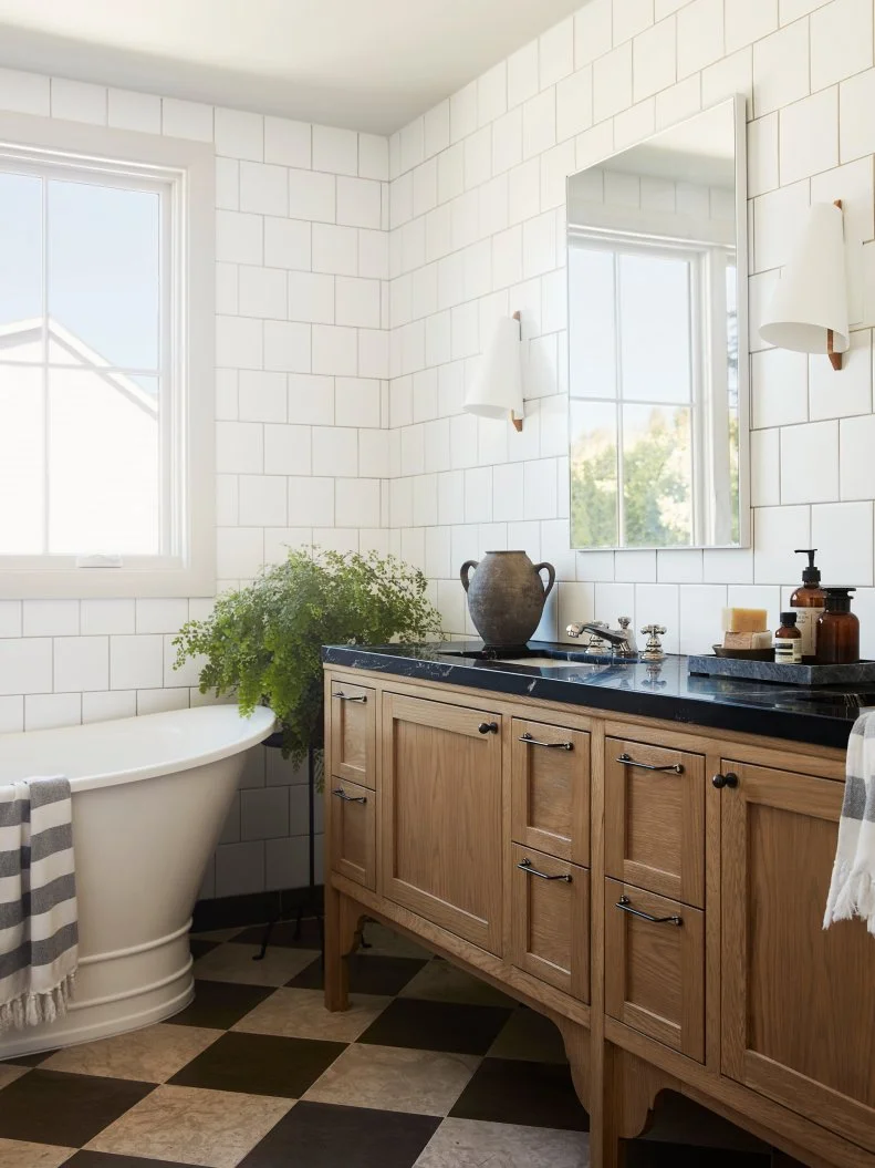 White Bathroom With Oak Vanity, Freestanding Tub and Checkered Floors
