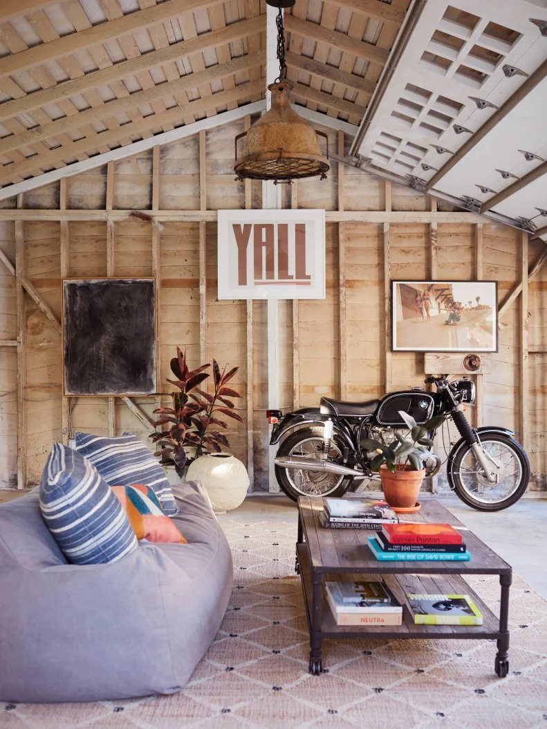 Neutral Renovated Garage With a Rustic Light and Sitting Area