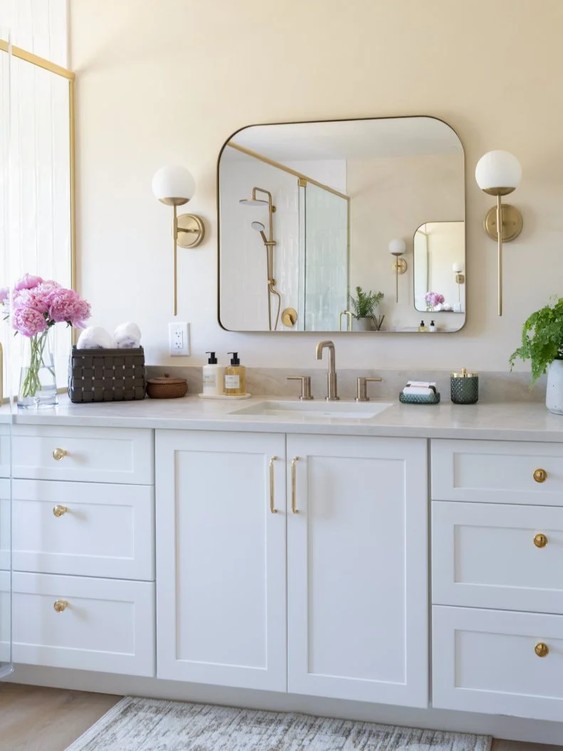 Primary bathroom shot showing vanity and part of the shower as seen on Totally 90s House, Season 1.