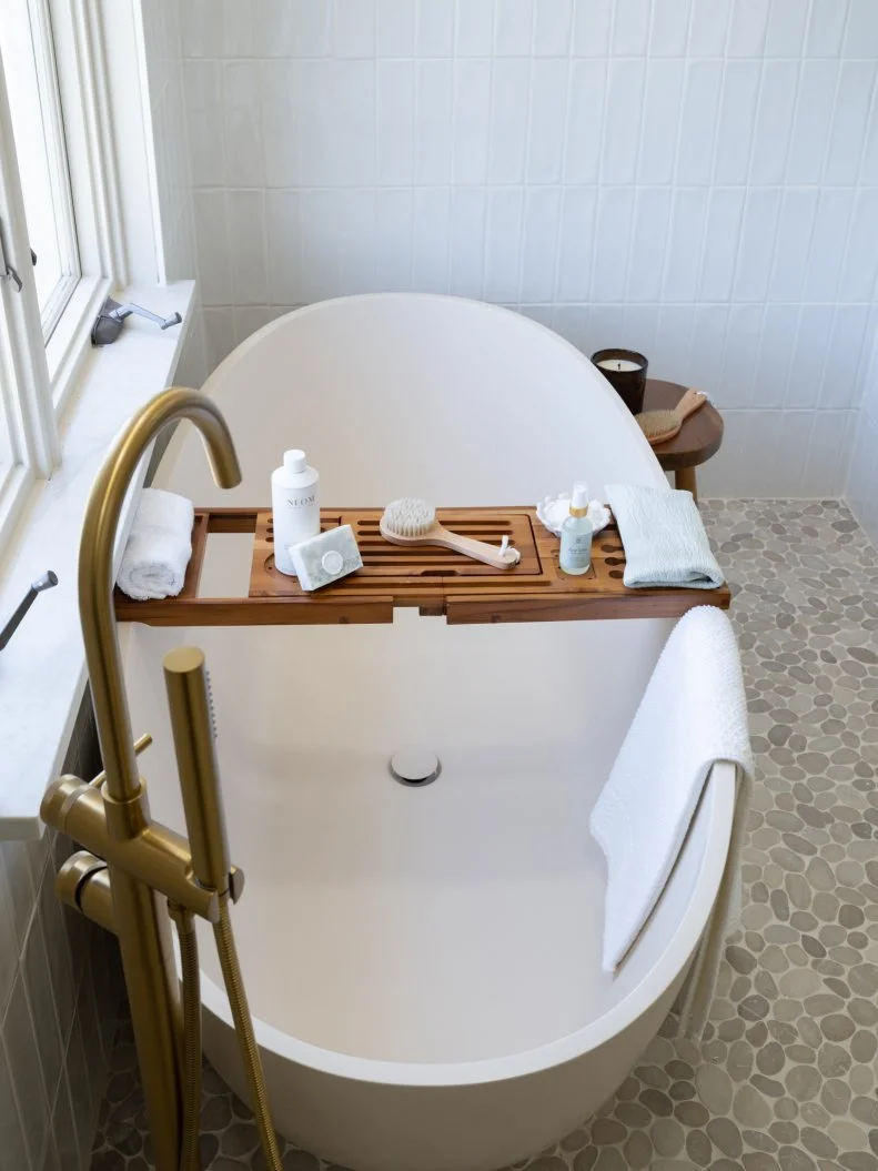 primary bathroom shot of bath tub in shower as seen on Totally 90s House, Season 1.