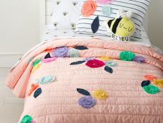 Create a haven that's tailored just for your kiddo with cozy, colorful bedding, bright lighting, fun artwork and charming rugs.