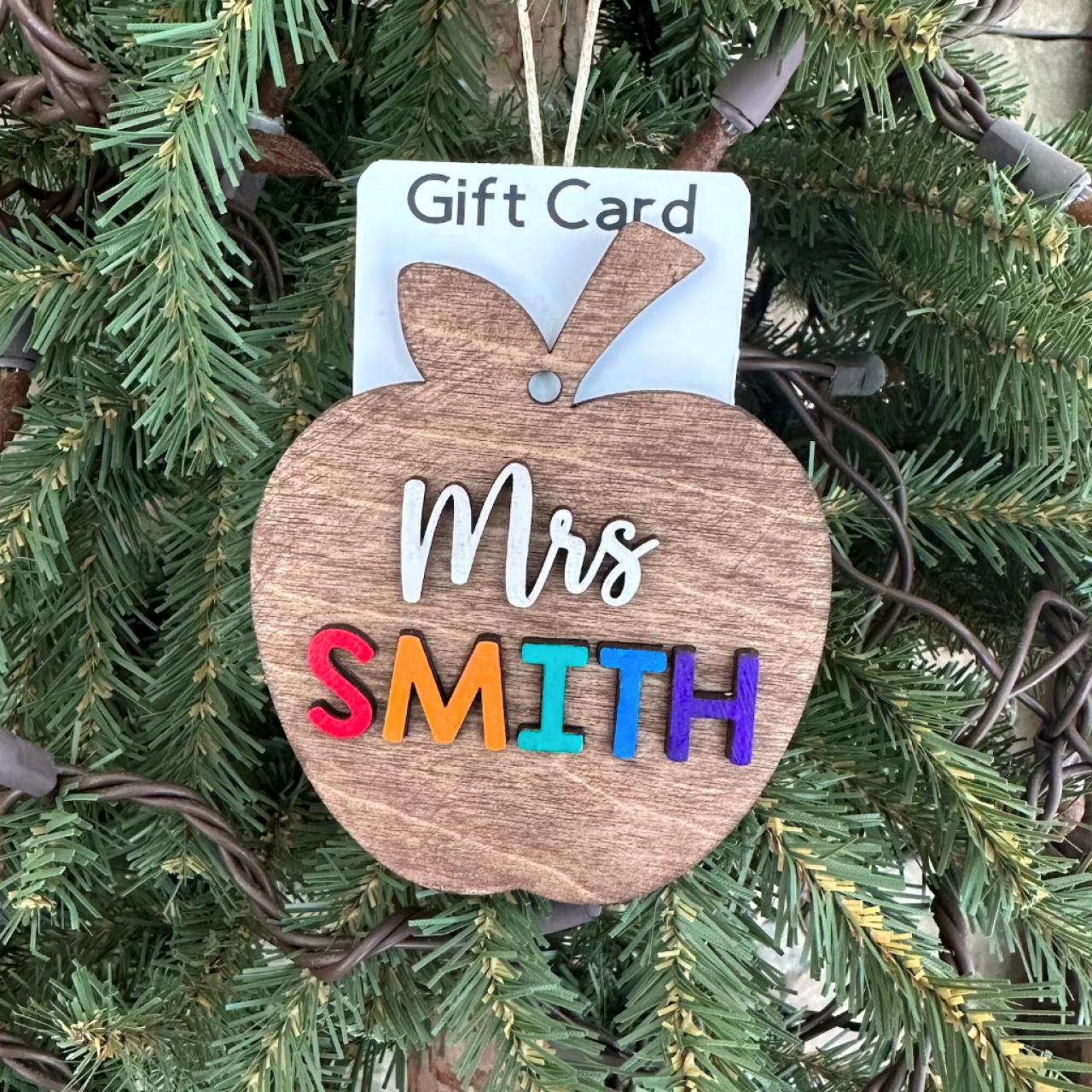 https://hgtvhome.sndimg.com/content/dam/images/hgtv/products/2022/11/22/rx_etsy_teacher-ornament-with-gift-card-holder-CROP.jpeg.rend.hgtvcom.1280.1280.suffix/1669153961407.jpeg