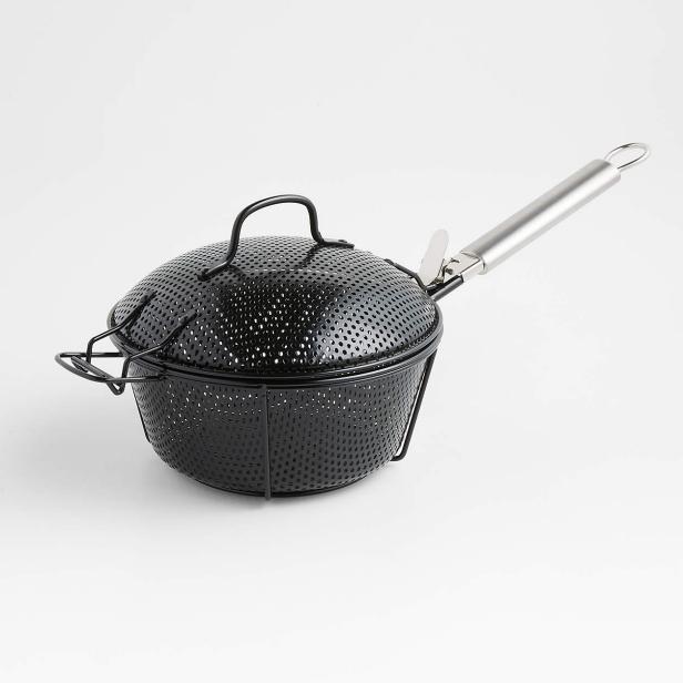 https://hgtvhome.sndimg.com/content/dam/images/hgtv/products/2022/3/1/1/rx_crateandbarrel_crate-and-barrel-outdoor-round-non-stick-bbq-grill-basket-with-lid.jpeg.rend.hgtvcom.616.616.suffix/1646148226894.jpeg