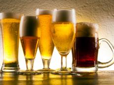 Five Types Of Beer Glasses With Four Different Flavours Of Beer Isolated On White Background