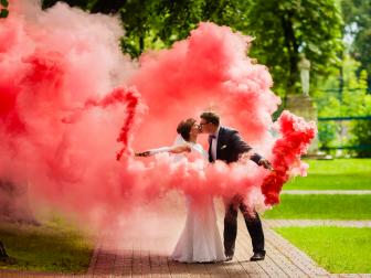 Bride and groom with a bright red smoke