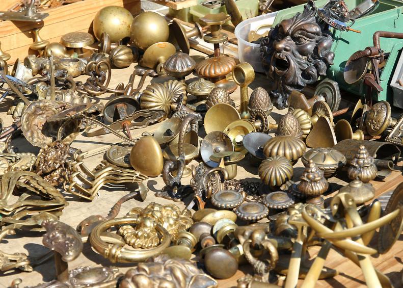 collection of ancient bronze handles for sale at flea market
