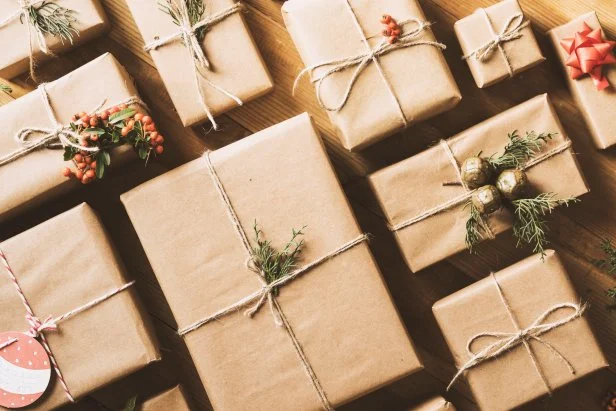 New Year, Christmas concept table top flat lay on wooden background. Wrapped gift boxes with ornaments.