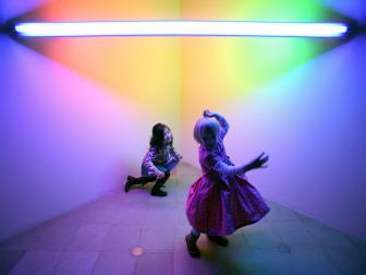Olivia Bailey 4, (center dancing) and Ruyi Rix 4 ( left)  play amongst the exhibits, at a series of workshops being held at the Hayward Gallery, on London's South Bank, during the run of the Dan Flavin Exhibition, Monday February 13 2006.
Photographer: Graham Barclay/Bloomberg News