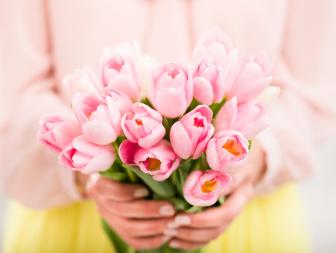 Bunch of tulips in woman's hands, shallow dof.