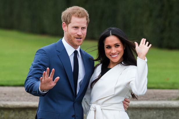 Prince Harry and Meghan Markle, wearing a white belted coat by Canadian brand Line The Label, attend a photocall in the Sunken Gardens at Kensington Palace, London following their engagement announcement on November 27, 2017.