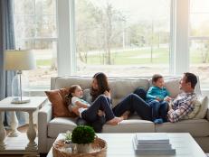 Shot of a happy young family of four relaxing together on the sofa at home