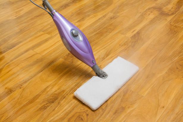 Using a steam mop to clean wooden floor