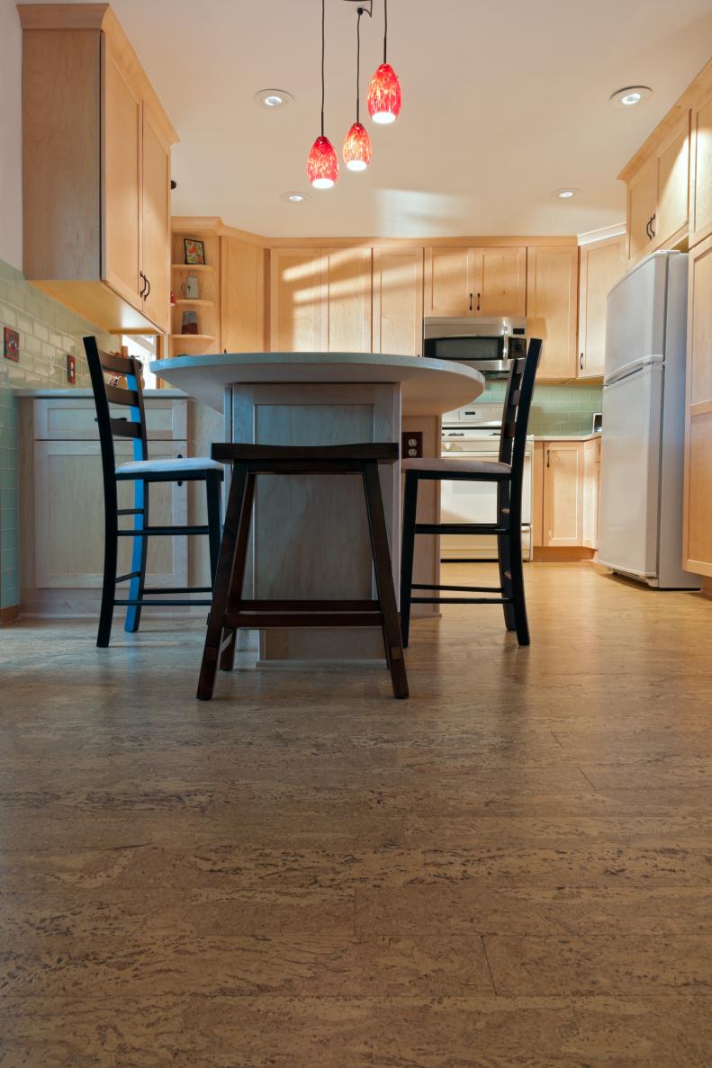 Newly remodeled kitchen interior with cork floors maple cabinets and pendant lights