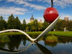 Spoonbridge and Cherry over a pond in Minneapolis Sculpture Garden with Saint Mary Basilica. (Photo by: Education Images/Universal Images Group via Getty Images)