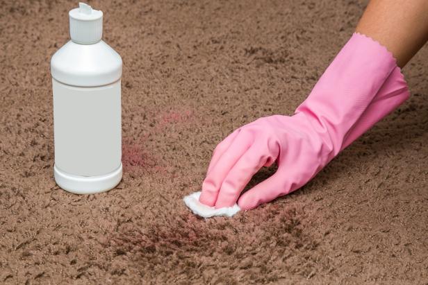 Nail polish stain cleaning with special chemical liquid. Carpet cleaning. Early spring cleaning or regular clean up. Inscriptions from the bottle is removed.