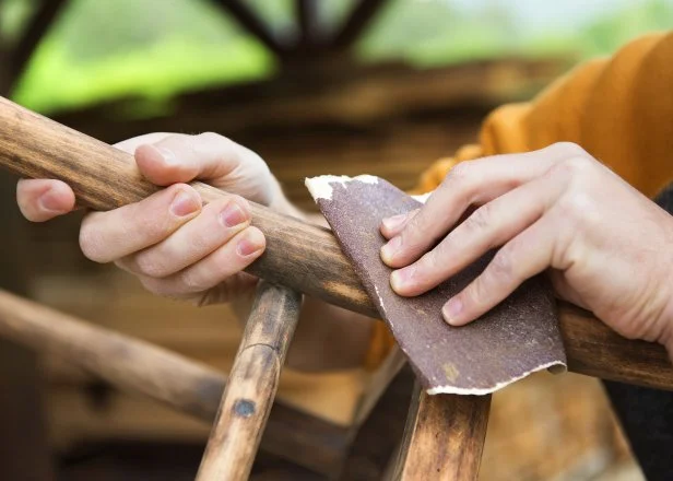 Restoration, removing paint from antique chair with sandpaper