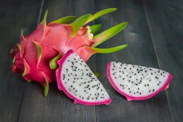 Ripe Dragon fruit or Pitaya with slice on wooden background