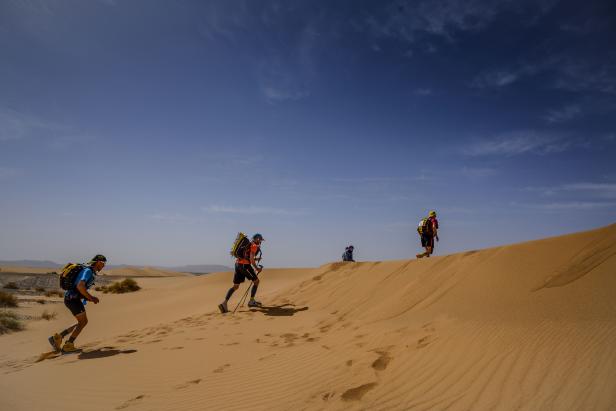 People compete in the stage 3 of the 34th edition of the Marathon des Sables between Kourci Dial Zaid and Jebel El MraÃ¯er in the southern Moroccan Sahara desert, on April 9, 2019. - The 34th edition of the marathon is a live stage 250 kilometres race through a formidable landscape in one of the world's most inhospitable climates. (Photo by JEAN-PHILIPPE KSIAZEK / AFP)        (Photo credit should read JEAN-PHILIPPE KSIAZEK/AFP via Getty Images)