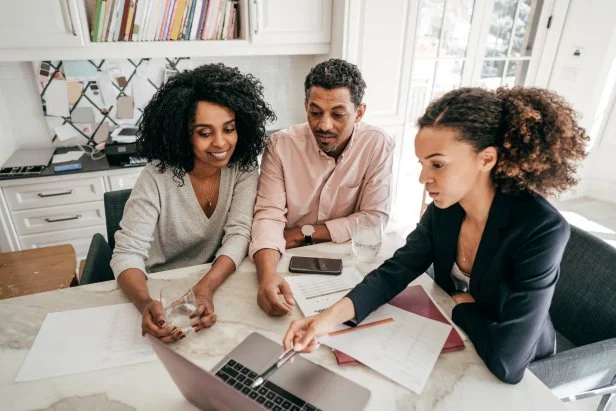 An accountant explaining insurance options to a couple.