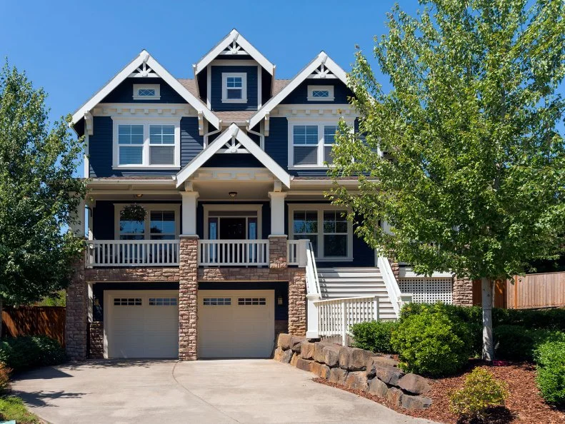 Two car garage Victorian Bungalow style single family home in North America suburban neighborhood
