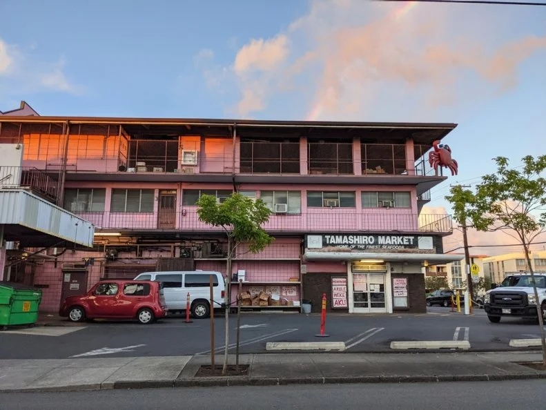 Honolulu - April 11, 2021: Vibrant pink storefront of Tamashiro Market Home of the Finest Seafoods in Honolulu, Hawaii. The market is a family-owned business that sells fresh and frozen seafood.